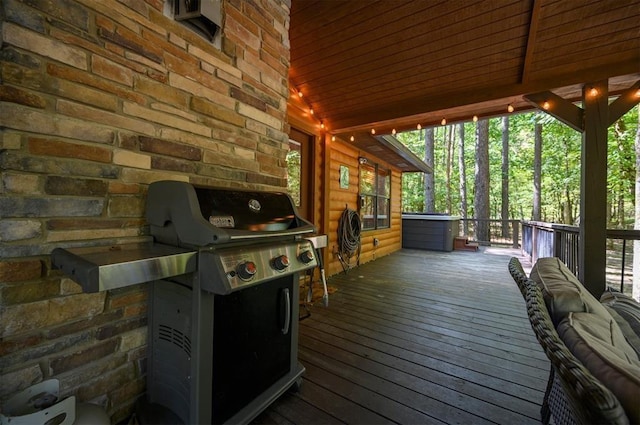 wooden terrace featuring grilling area and a jacuzzi