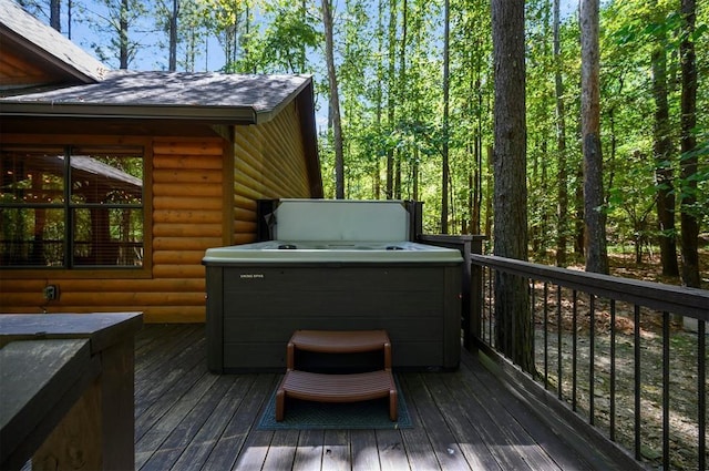 wooden deck featuring a hot tub