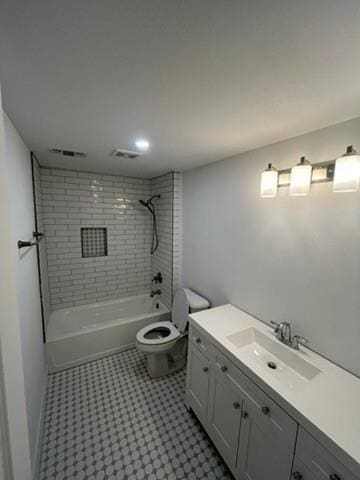 full bathroom with vanity, toilet, and tiled shower / bath combo