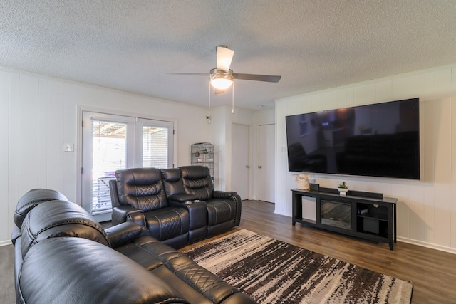 living area with dark wood-style floors, ceiling fan, and a textured ceiling