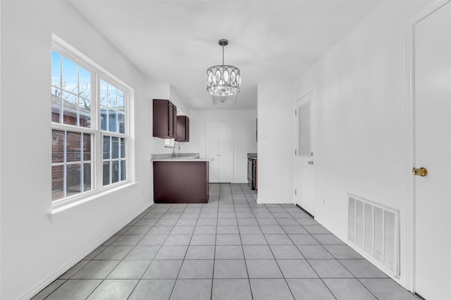 1308 Abbott Dr, Irving, TX 75060 - kitchen featuring a chandelier, light countertops, baseboards, and pendant lighting