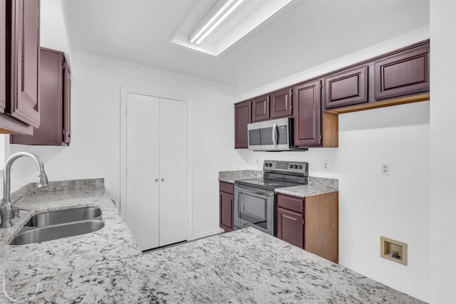 1308 Abbott Dr, Irving, TX 75060 - kitchen with stainless steel appliances, a sink, and light stone counters