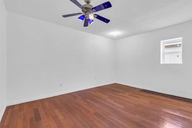 spare room featuring wood-type flooring and ceiling fan