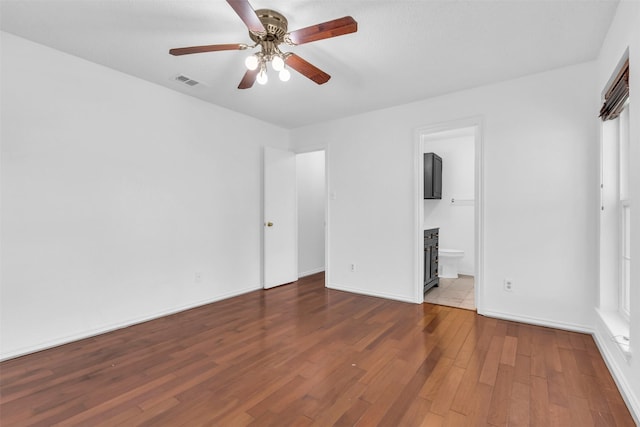 1308 Abbott Dr, Irving, TX 75060 - unfurnished bedroom featuring wood finished floors, ensuite bath, baseboards, and ceiling fan