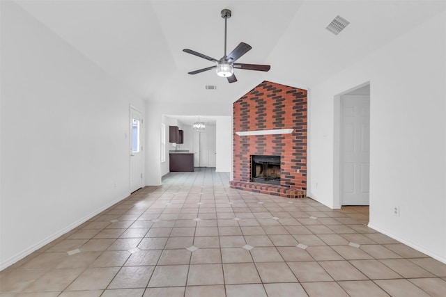 1308 Abbott Dr, Irving, TX 75060 - unfurnished living room with ceiling fan, vaulted ceiling, a brick fireplace, a chandelier, and light tile patterned floors