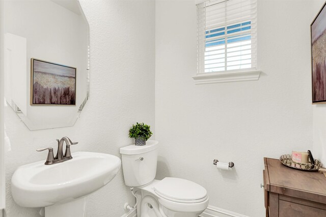 bathroom featuring sink and toilet