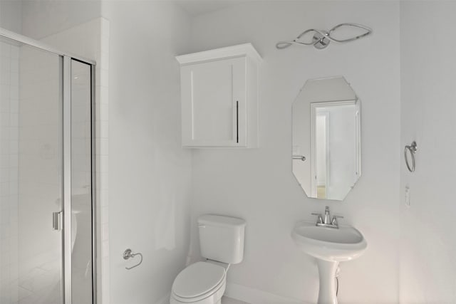 bathroom featuring toilet and walk in shower