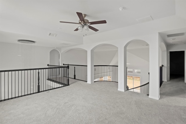 spare room with ceiling fan and light carpet