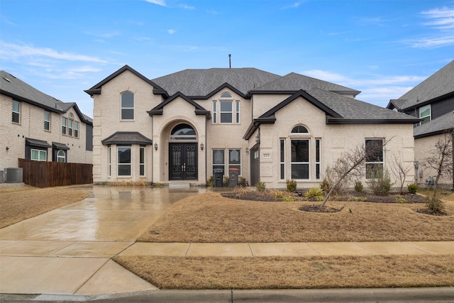 french country inspired facade featuring cooling unit