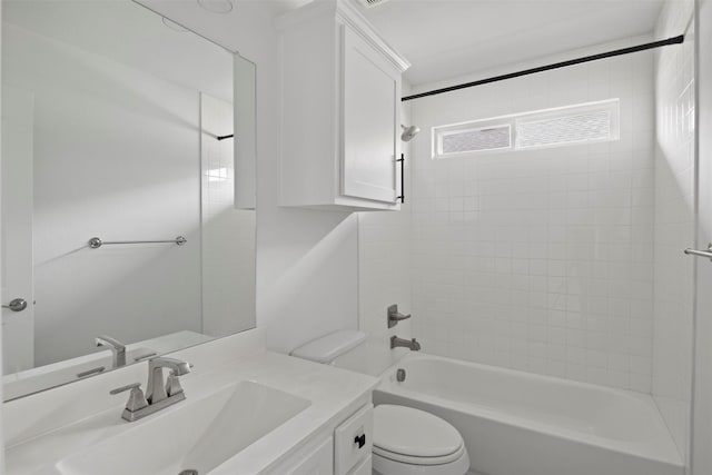 full bathroom with vanity, toilet, and tiled shower / bath