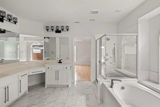 bathroom with vanity and separate shower and tub