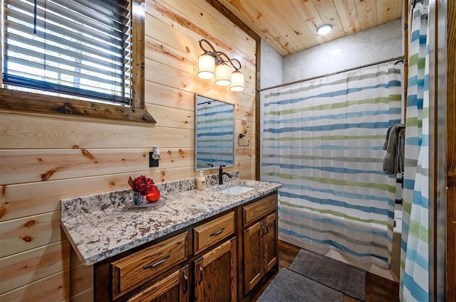 bathroom featuring vanity, wooden ceiling, wooden walls, and a shower with shower curtain