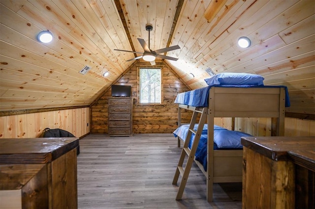 unfurnished bedroom featuring lofted ceiling, wood ceiling, wooden walls, and hardwood / wood-style flooring