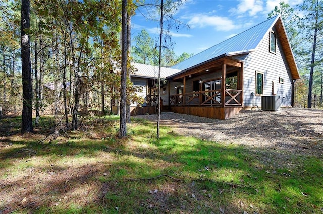 back of property featuring a porch and central AC