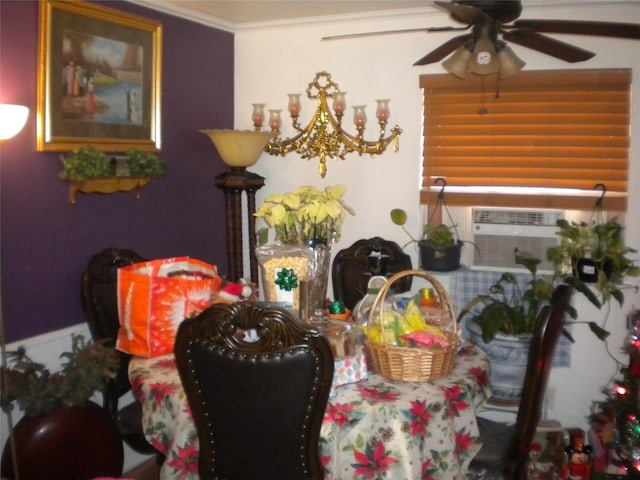 dining area with crown molding, ceiling fan with notable chandelier, and cooling unit