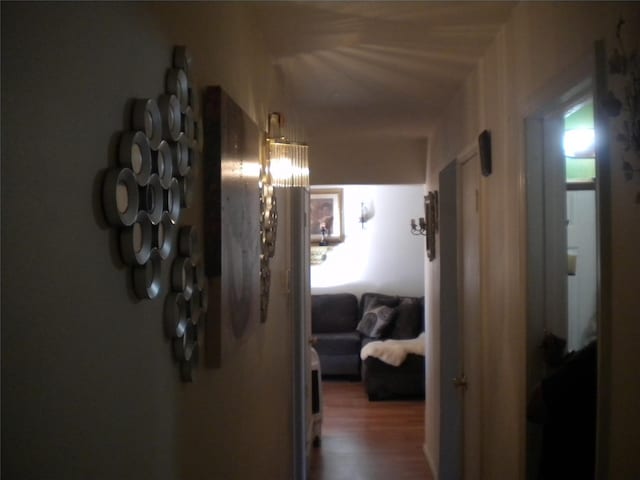 hallway with hardwood / wood-style flooring