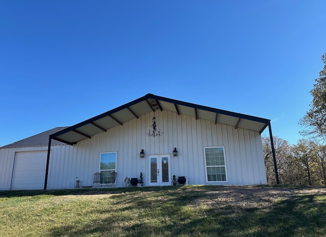 rear view of property featuring french doors and a yard