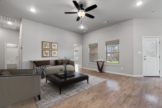 living room featuring ceiling fan and light wood-type flooring