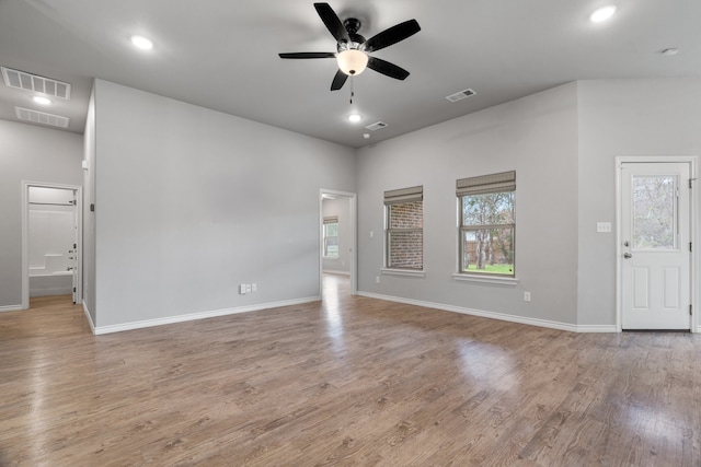 unfurnished living room with ceiling fan and light wood-type flooring