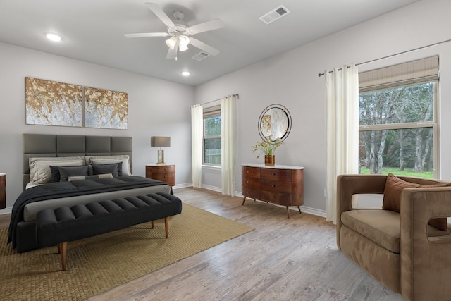 bedroom with ceiling fan and light hardwood / wood-style floors