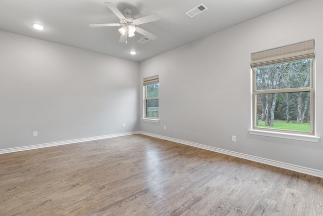 spare room with ceiling fan and light hardwood / wood-style flooring