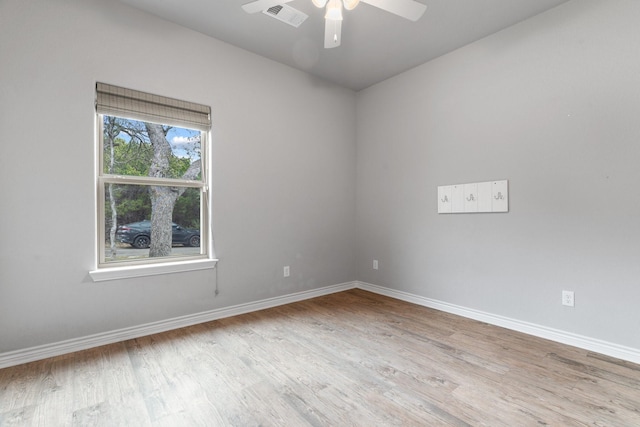 spare room with ceiling fan and light wood-type flooring