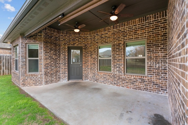 view of exterior entry featuring a patio and ceiling fan