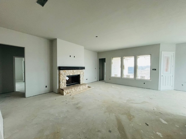 unfurnished living room with a stone fireplace