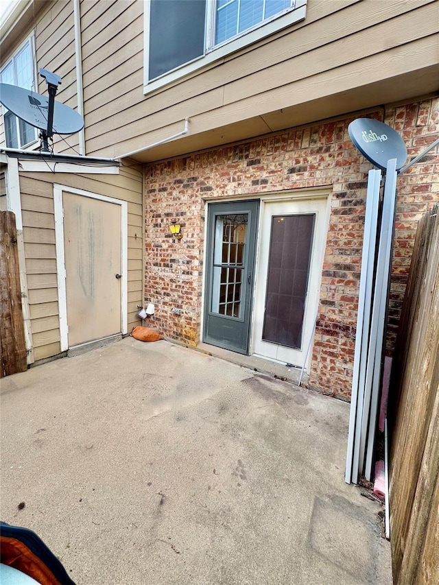 entrance to property featuring a patio