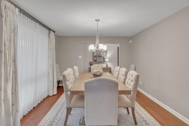 dining room featuring hardwood / wood-style flooring and a chandelier