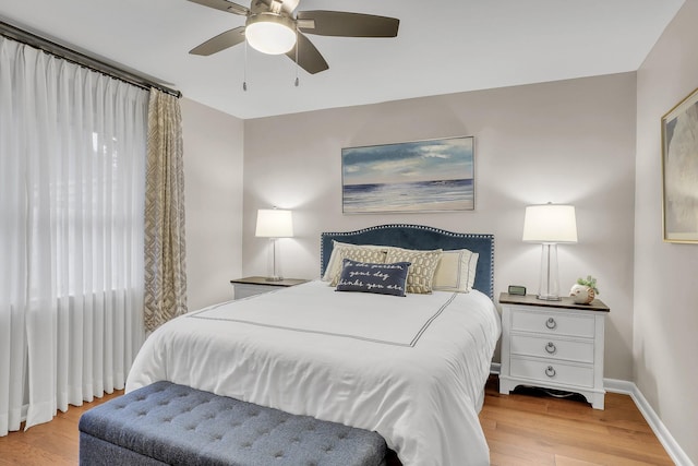 bedroom with light hardwood / wood-style floors and ceiling fan