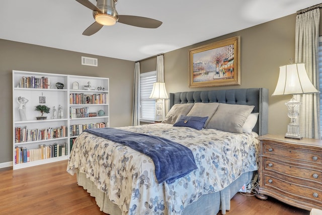 bedroom with ceiling fan and hardwood / wood-style floors