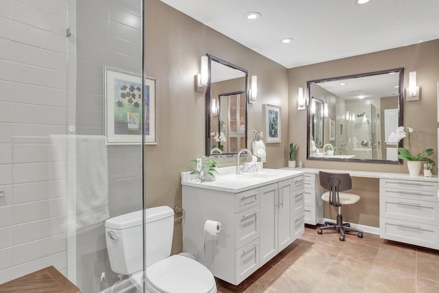 bathroom with tile patterned flooring, vanity, walk in shower, and toilet