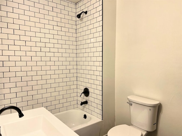 bathroom featuring tiled shower / bath and toilet