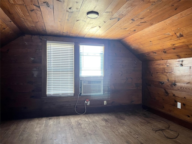 additional living space with lofted ceiling, wooden ceiling, dark hardwood / wood-style floors, and wood walls