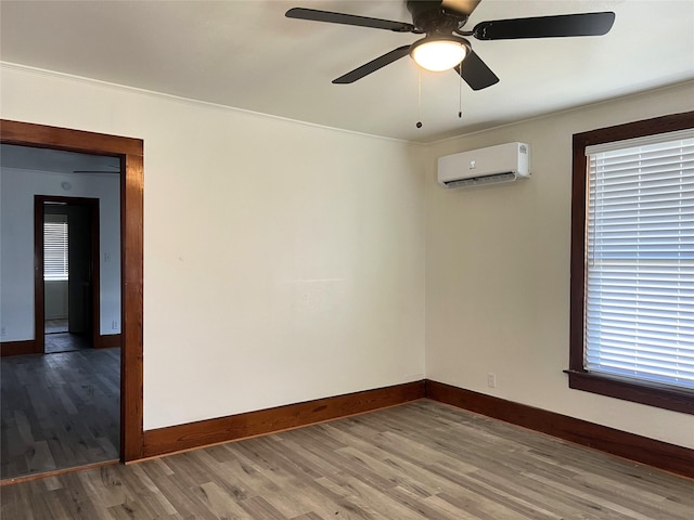 unfurnished room with wood-type flooring, crown molding, ceiling fan, and a wall unit AC