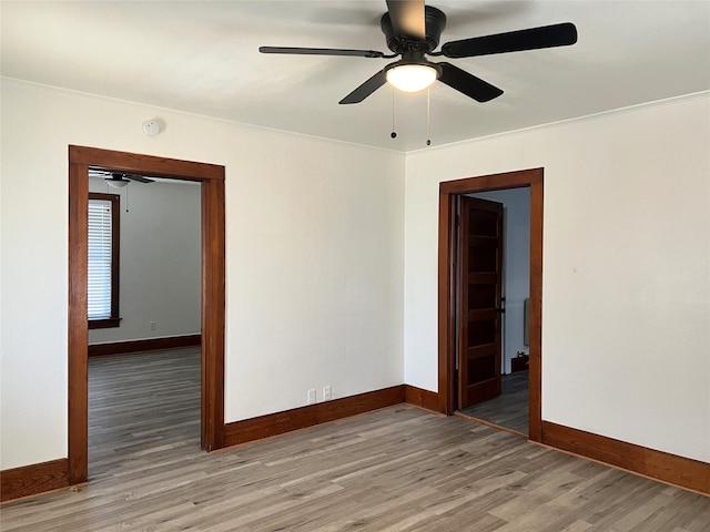 empty room with wood-type flooring and ornamental molding