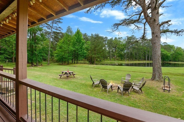 exterior space featuring a water view and an outdoor fire pit