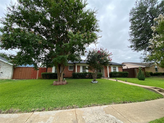 ranch-style home with a front lawn