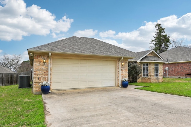 ranch-style house with a garage, a front yard, and central air condition unit