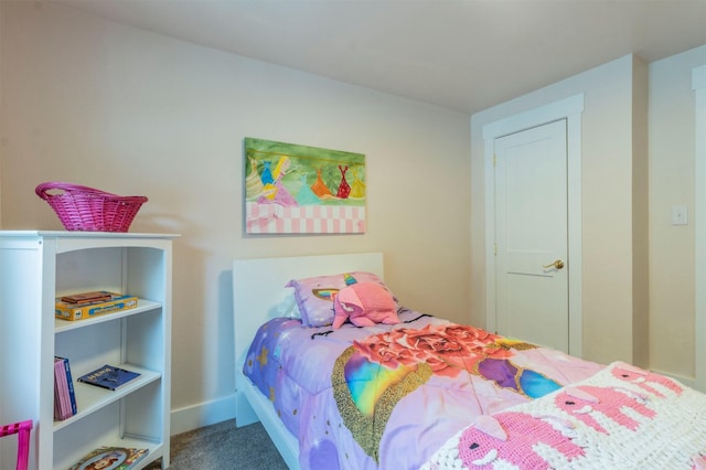 bedroom featuring carpet and baseboards