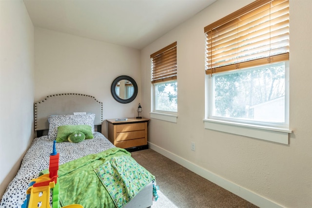 bedroom featuring carpet and baseboards