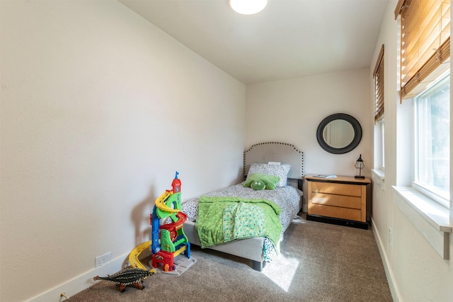 carpeted bedroom featuring baseboards