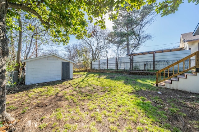 view of yard with stairway, an outdoor structure, and fence