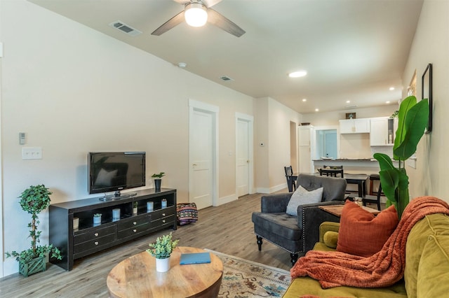 living area featuring visible vents, ceiling fan, baseboards, light wood-type flooring, and recessed lighting