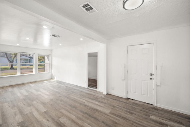 2717 Eagle Dr, Dallas, TX 75216 - spare room with wood-type flooring and a textured ceiling