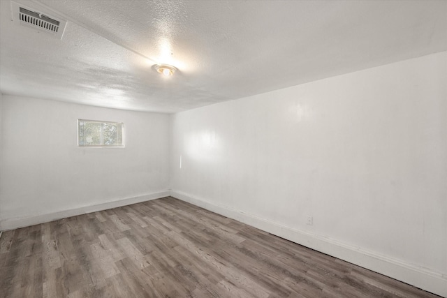 2717 Eagle Dr, Dallas, TX 75216 - spare room with hardwood / wood-style floors and a textured ceiling