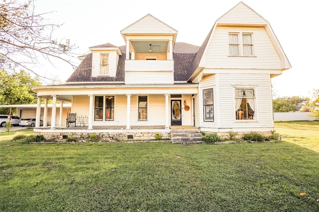 view of front facade featuring covered porch and a front yard