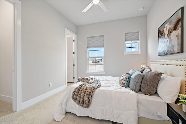 carpeted bedroom with baseboards and a ceiling fan