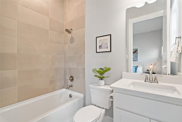 bathroom featuring toilet, vanity, bathing tub / shower combination, and a textured wall